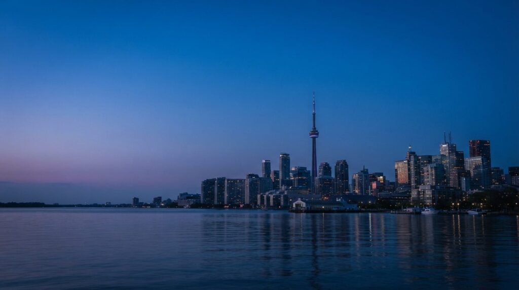 The Toronto skyline and CN Tower at blue hour seen across the water, representing the Toronto local search market