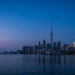 The Toronto skyline and CN Tower at blue hour seen across the water, representing the Toronto local search market