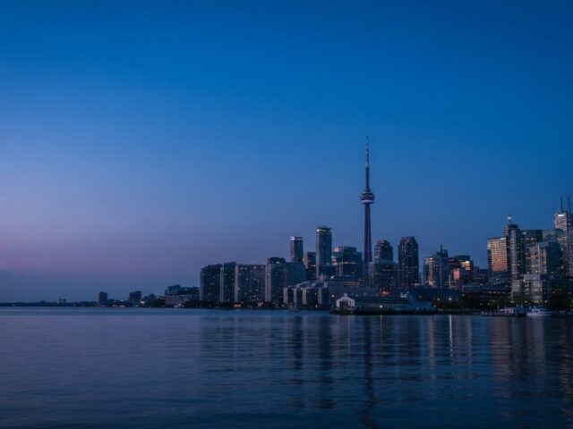 The Toronto skyline and CN Tower at blue hour seen across the water, representing the Toronto local search market