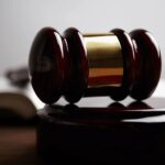 A judge's gavel resting on an open law book, representing Canadian legal rules on false and misleading website claims