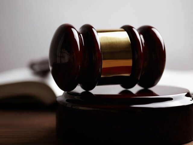 A judge's gavel resting on an open law book, representing Canadian legal rules on false and misleading website claims